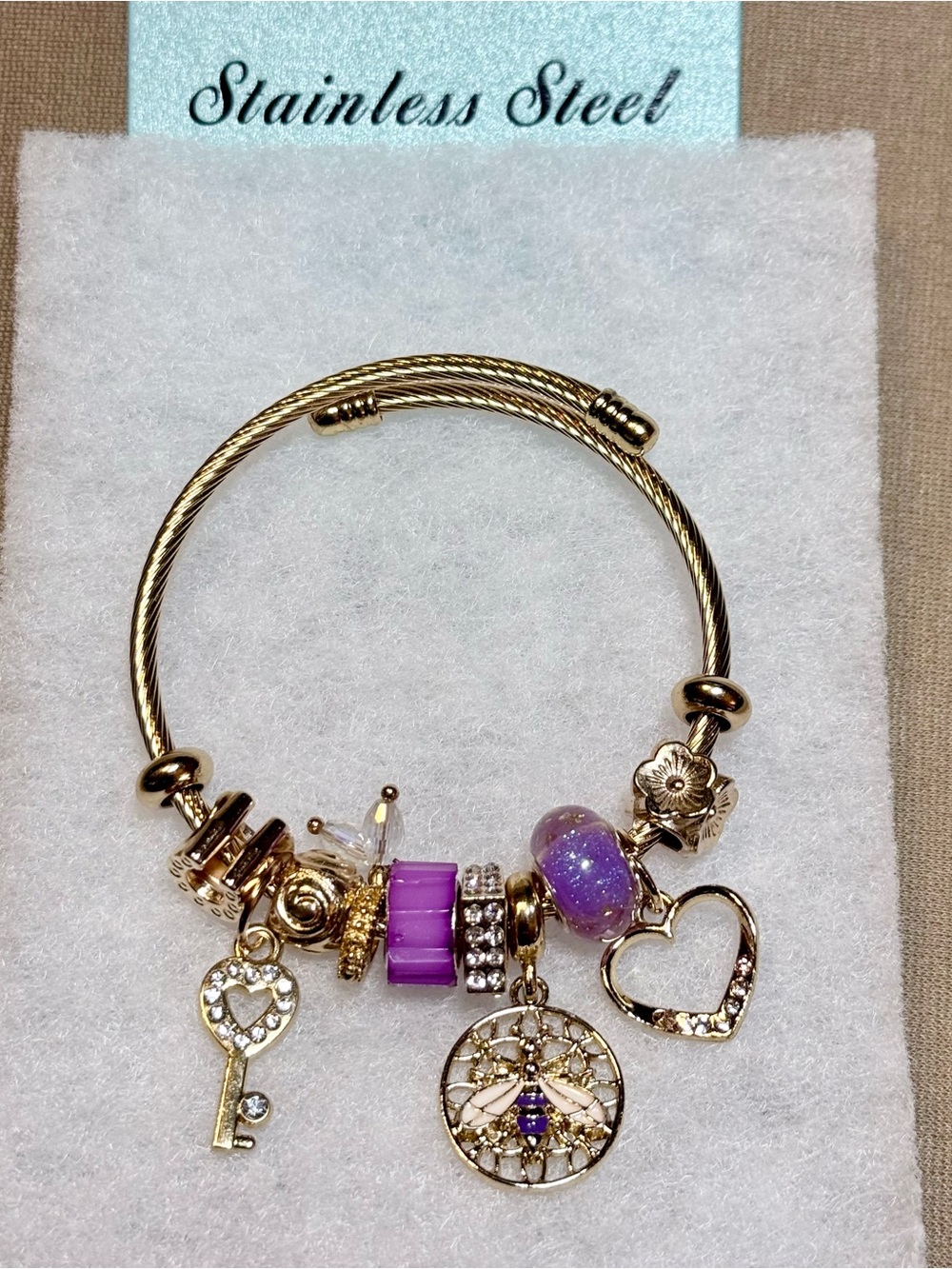 Gold-Tone Stainless Steel Bracelet with Purple & Gold Charms